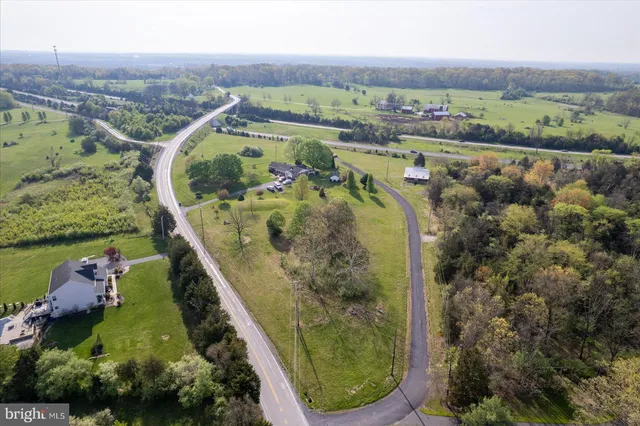 an aerial view of a residential houses with outdoor space