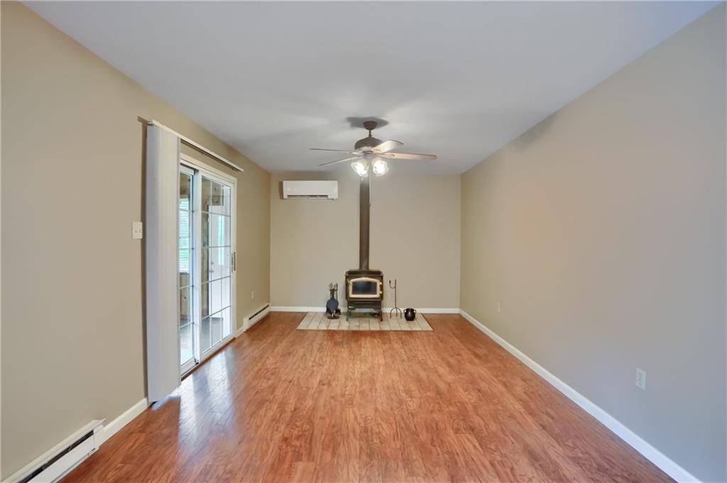 7950 Franklin Road Evans City, PA 16033 - Photo 22 of 43 Fireplace easily warms this space and the kitchen. Leave sliding doors open and it will heat the 3 season room making it a 4 season room!