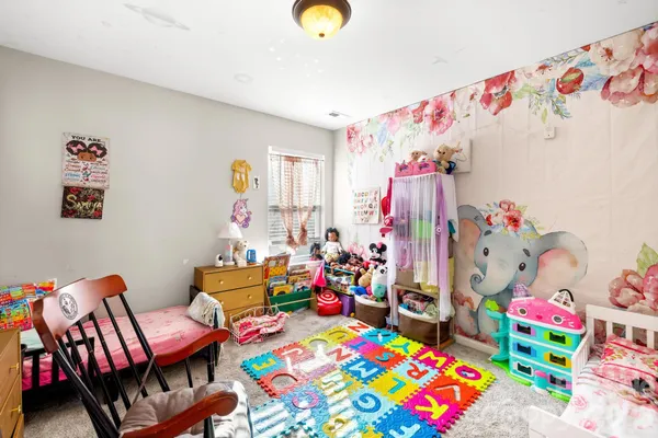 a bedroom with toys and a baby crib