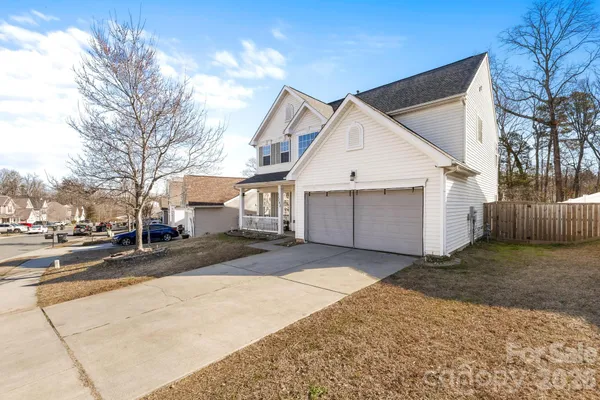 a view of a white house with a yard covered in snow