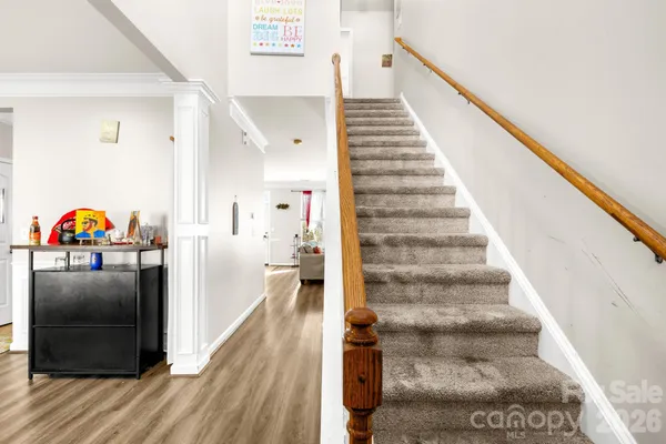a view of entryway and hall with wooden floor