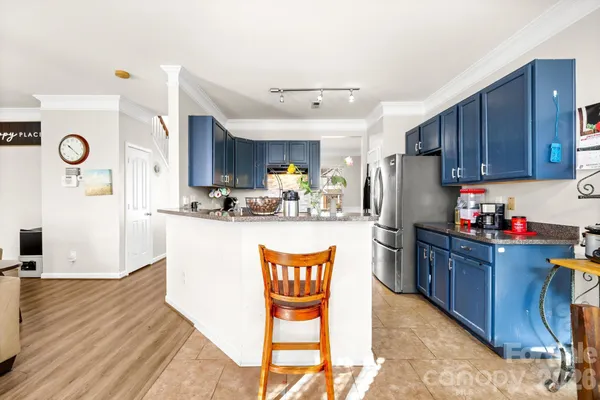 a kitchen with refrigerator cabinets and wooden floor