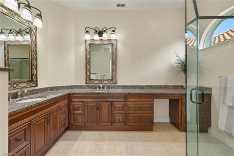 a spacious bathroom with a granite countertop sink and a mirror