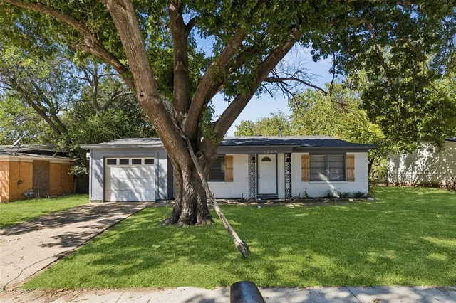 a house with green field in front of it
