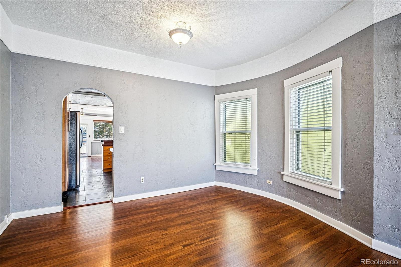 354 North Washington Street Denver, CO 80203 - Photo 11 of 43 an empty room with wooden floor and windows