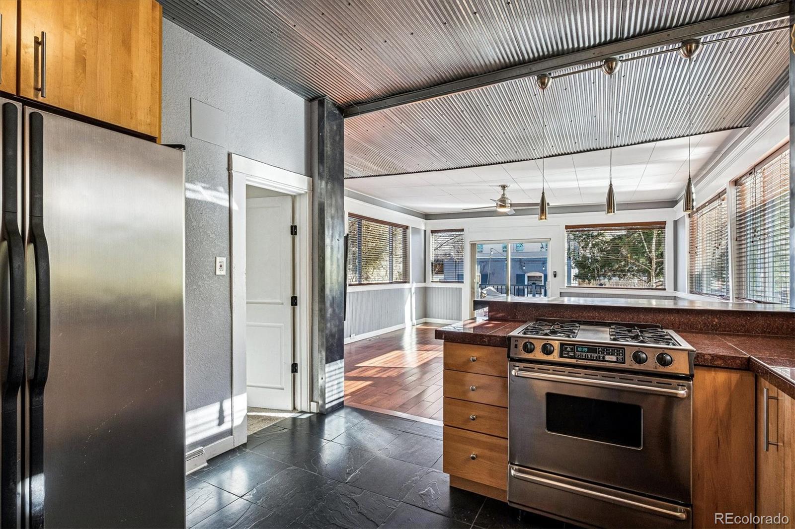 354 North Washington Street Denver, CO 80203 - Photo 14 of 43 a kitchen with stainless steel appliances granite countertop a stove and a refrigerator