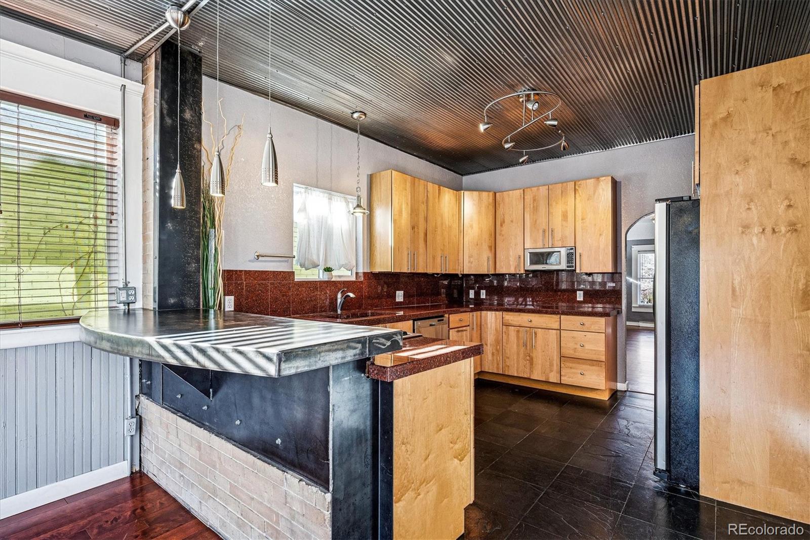 354 North Washington Street Denver, CO 80203 - Photo 16 of 43 a kitchen with stainless steel appliances granite countertop a sink stove and refrigerator