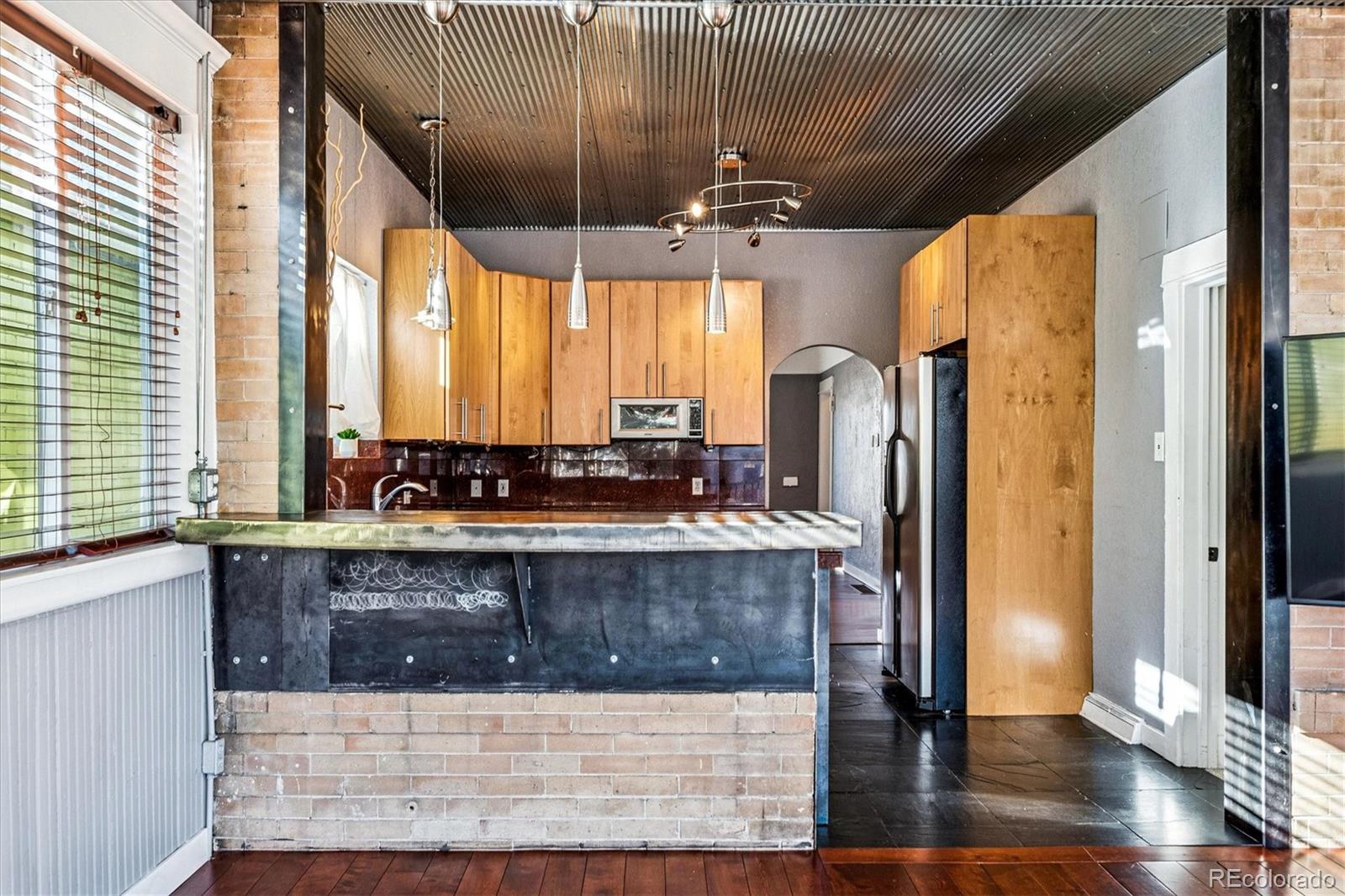 354 North Washington Street Denver, CO 80203 - Photo 18 of 43 a kitchen with stainless steel appliances granite countertop a sink and a refrigerator