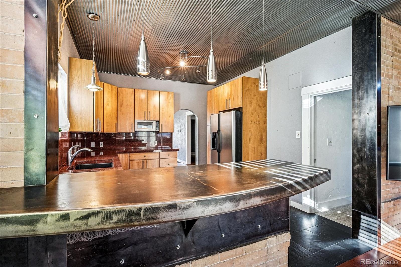 354 North Washington Street Denver, CO 80203 - Photo 19 of 43 a kitchen with stainless steel appliances granite countertop a sink a stove and a refrigerator