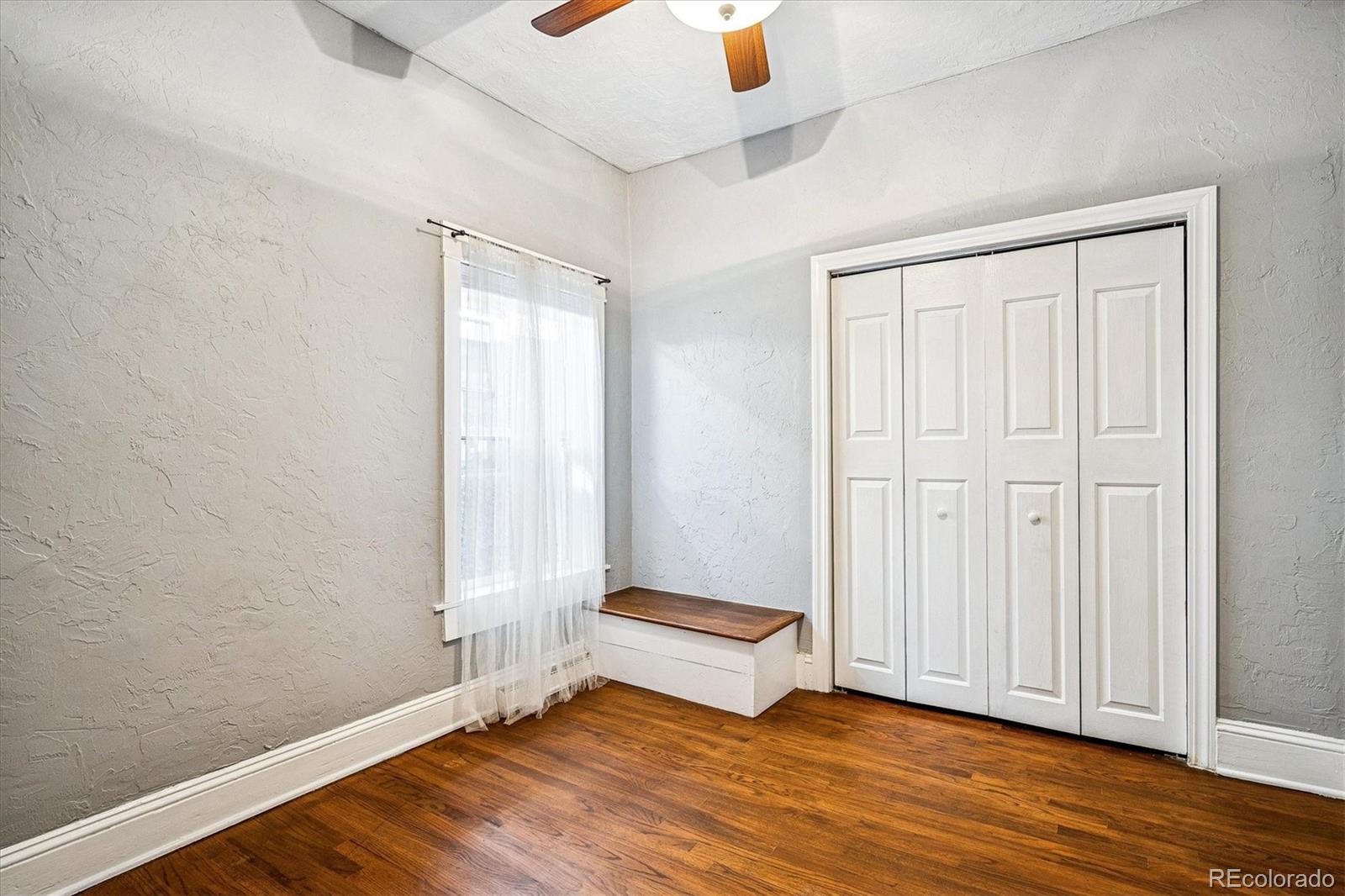 354 North Washington Street Denver, CO 80203 - Photo 27 of 43 an empty room with wooden floor and windows