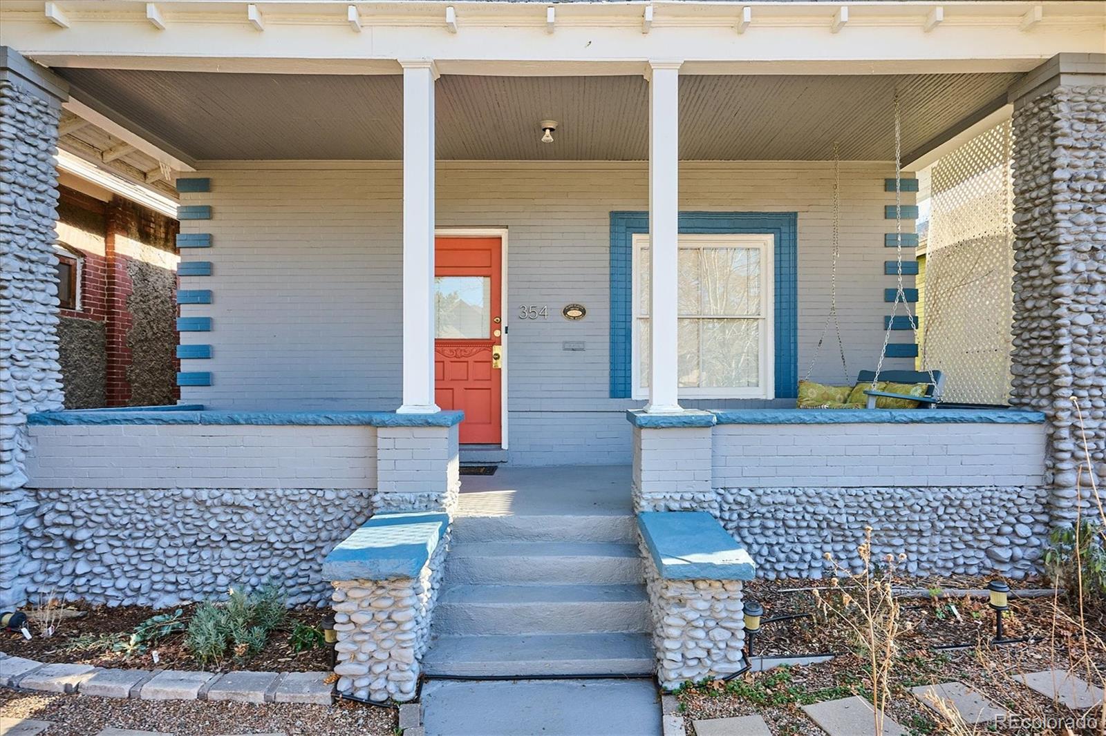 354 North Washington Street Denver, CO 80203 - Photo 4 of 43 a front view of a house with a garden