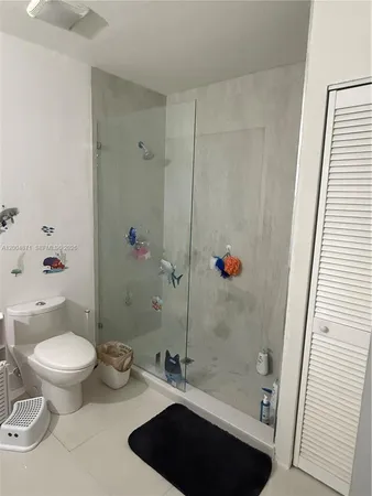 a bathroom with a toilet a sink and shower