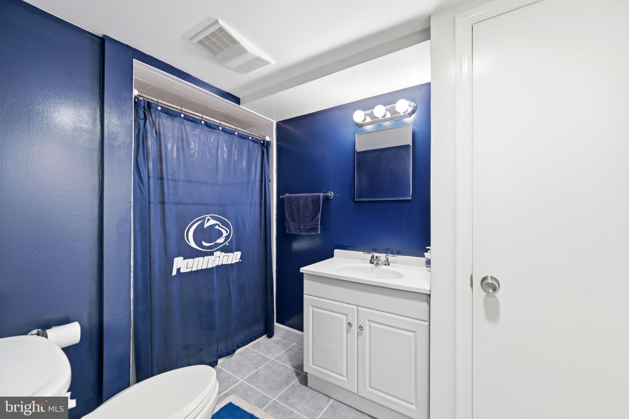 905 Amosland Road Morton, PA 19070 - Photo 38 of 44 Bold blue bathroom with modern fixtures.