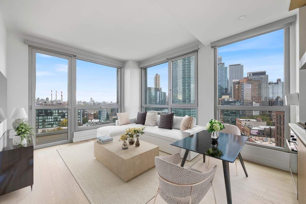 a living room with furniture and a floor to ceiling window