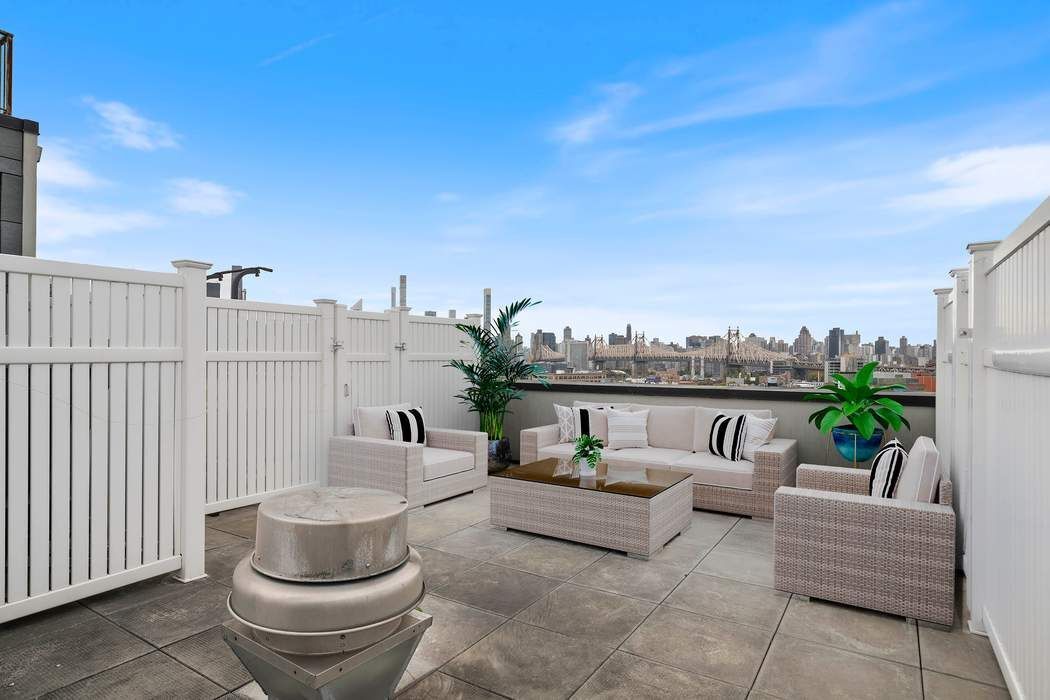 22-43 Jackson Avenue, Unit 11F Queens, NY 11101 - Photo 11 of 18 a balcony with furniture and a potted plant
