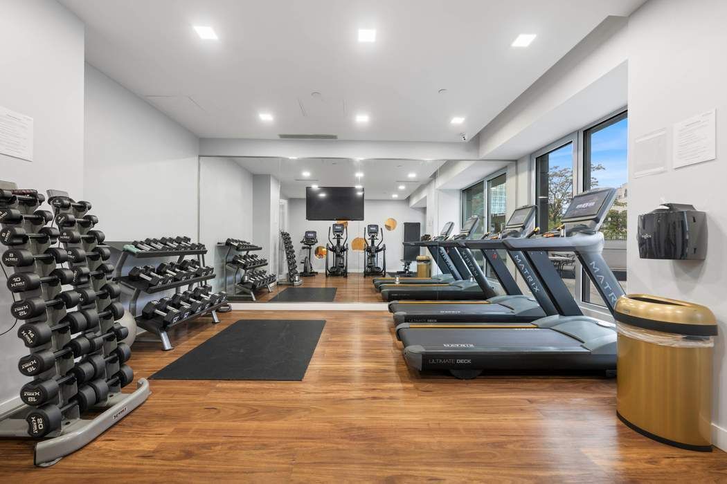 22-43 Jackson Avenue, Unit 11F Queens, NY 11101 - Photo 15 of 18 a living room with lots of furniture and wooden floor