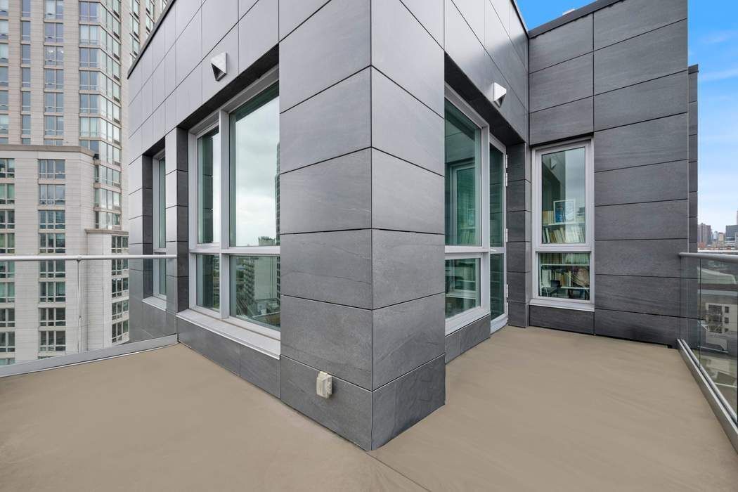 22-43 Jackson Avenue, Unit 11F Queens, NY 11101 - Photo 2 of 18 a view of a brick house with a large window