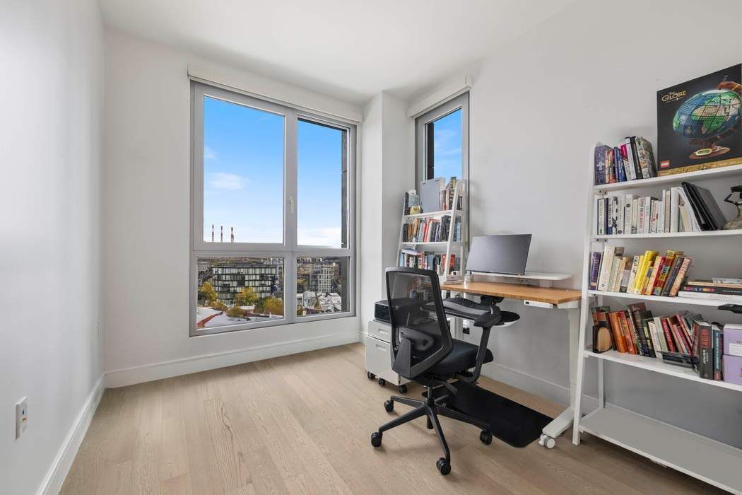 22-43 Jackson Avenue, Unit 11F Queens, NY 11101 - Photo 8 of 18 a view of a workspace with furniture and a window