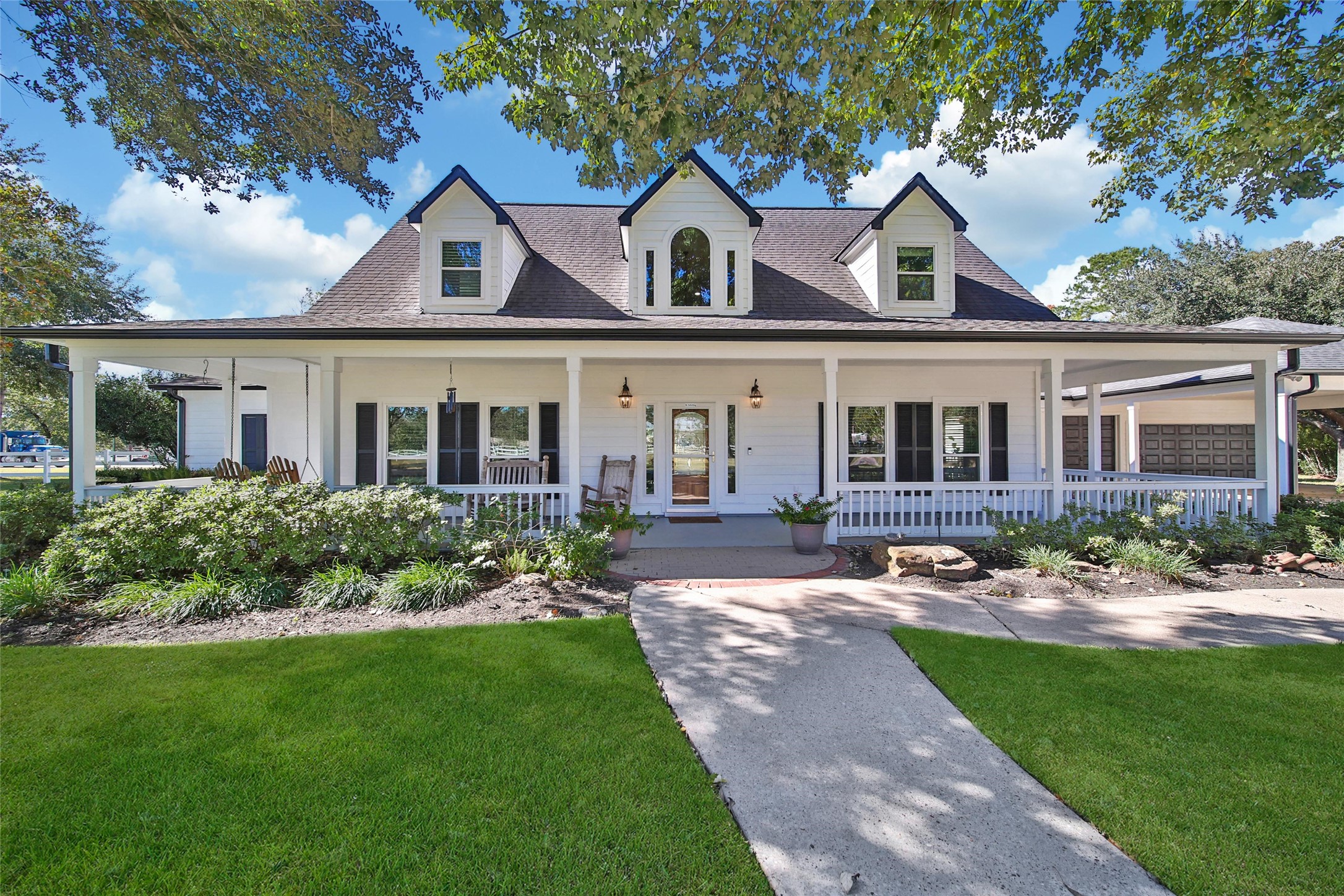 29919 Tudor Way Magnolia, TX 77355 - Photo 5 of 50 Farmhouse with a wraparound porch with lush landscaping.