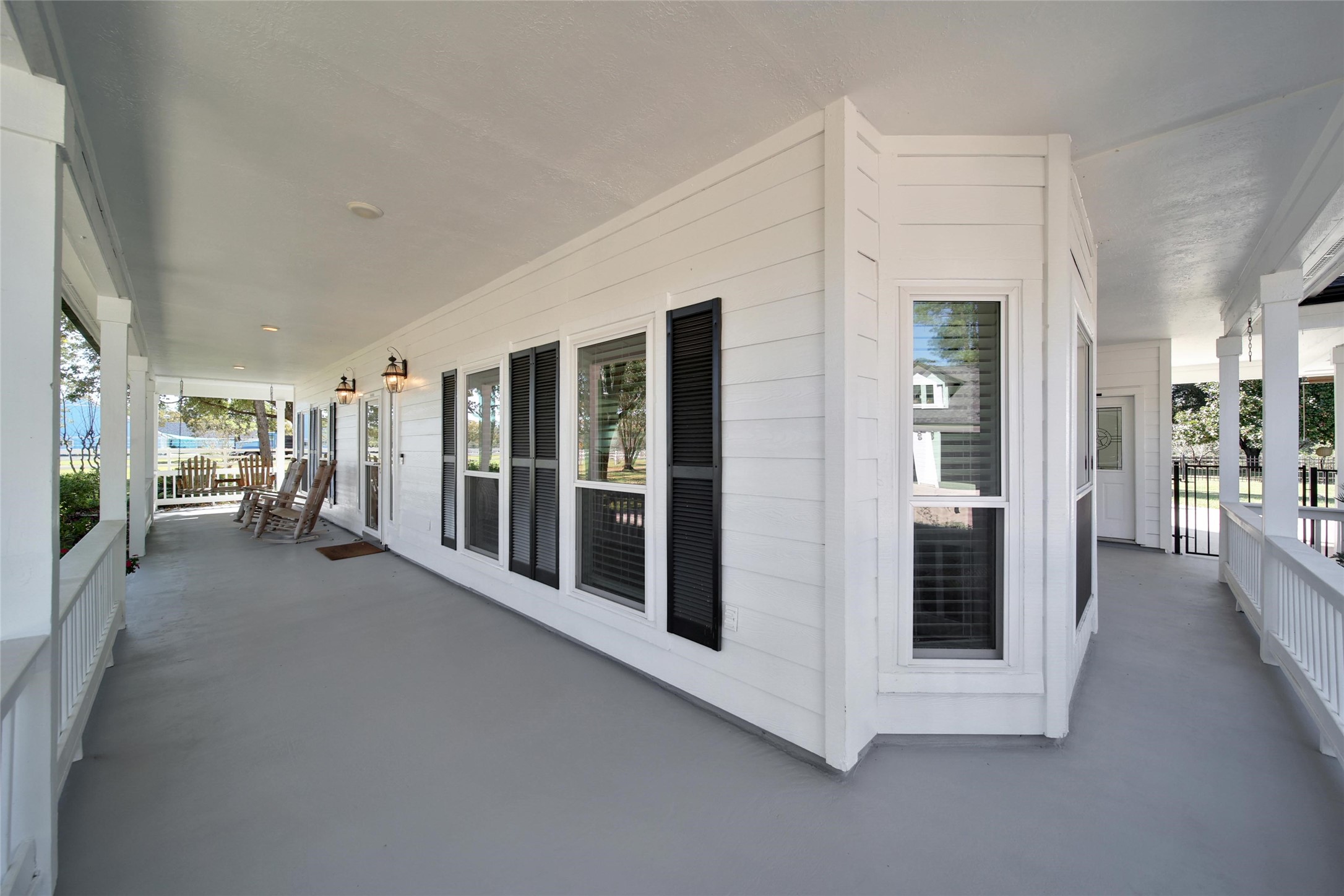 29919 Tudor Way Magnolia, TX 77355 - Photo 6 of 50 Relax on the covered wraparound porch and enjoy peaceful outdoor views