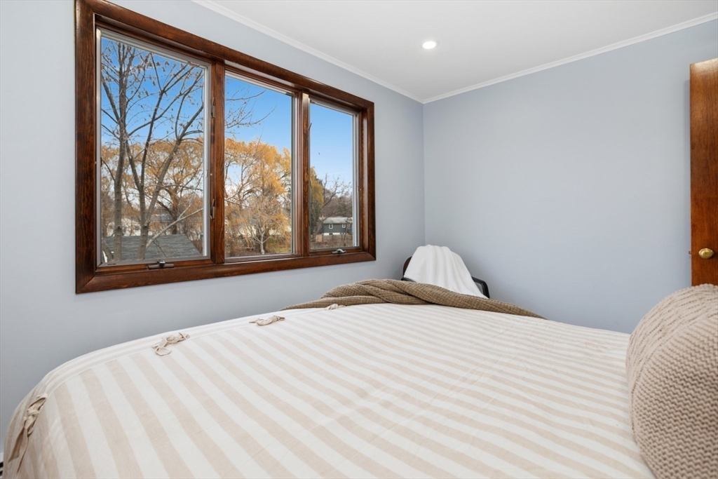 47 School Street Saugus, MA 01906 - Photo 12 of 30 a bedroom with a large bed and a large window