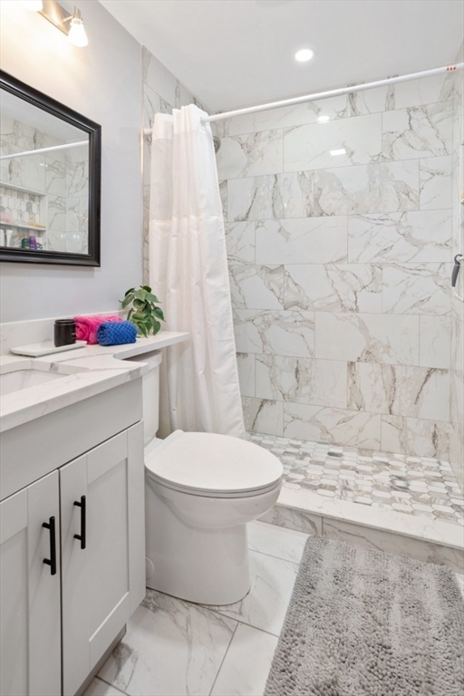 47 School Street Saugus, MA 01906 - Photo 14 of 30 a bathroom with a sink toilet and shower