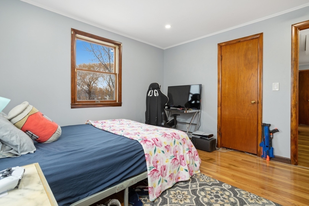 47 School Street Saugus, MA 01906 - Photo 18 of 30 a bedroom with a bed and dresser with mirror