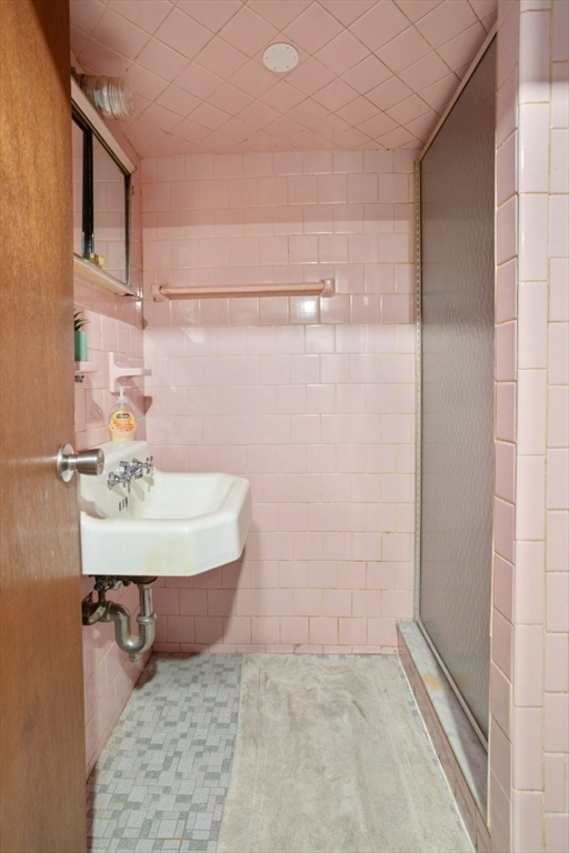 47 School Street Saugus, MA 01906 - Photo 20 of 30 a bathroom with a sink a mirror and shower