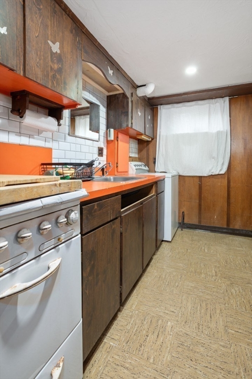 47 School Street Saugus, MA 01906 - Photo 24 of 30 a kitchen with stainless steel appliances granite countertop a sink and a stove
