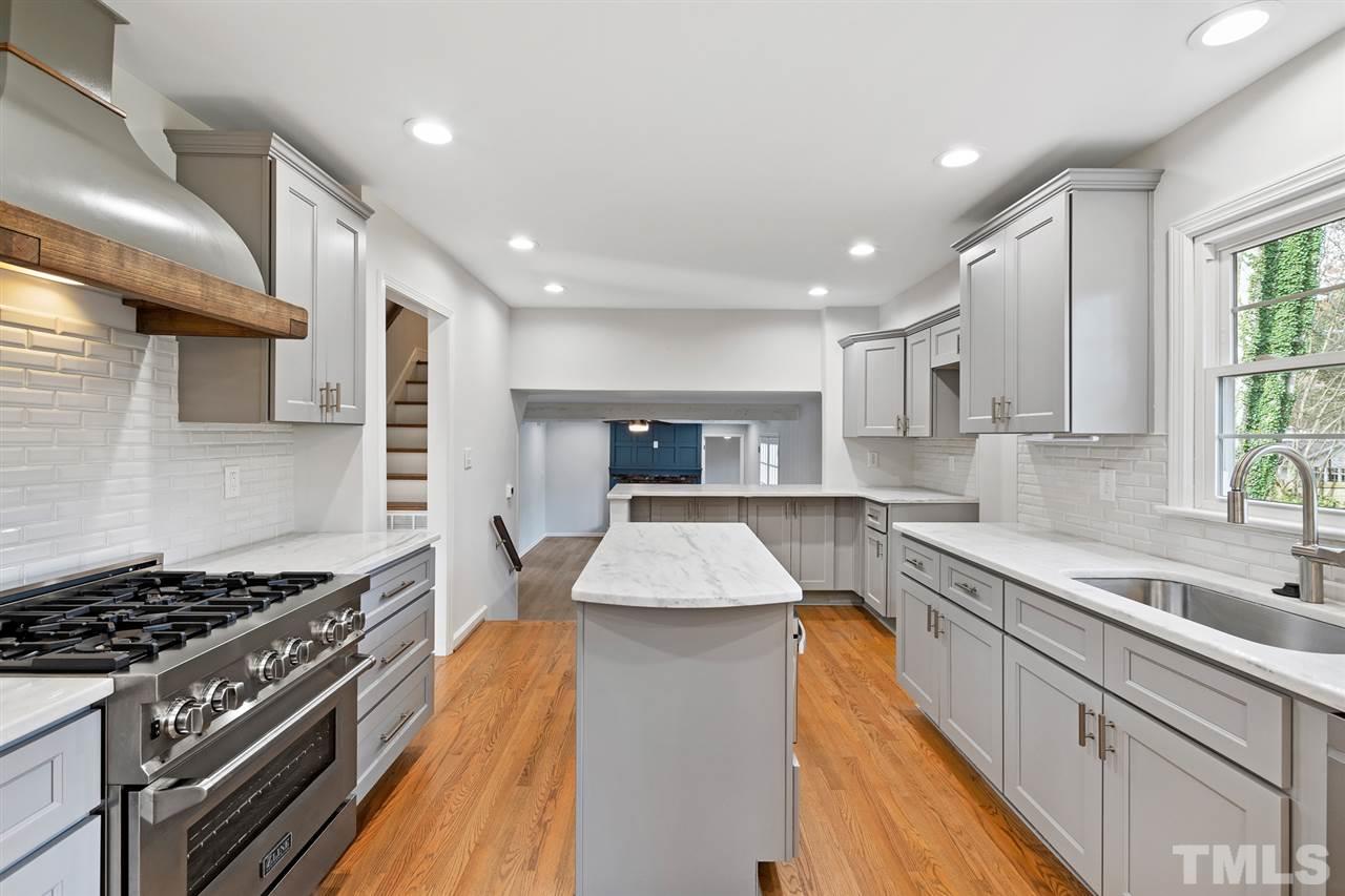 7605 Starling Court Raleigh, NC 27615 - Photo 11 of 30 a kitchen with stainless steel appliances granite countertop a sink stove and cabinets