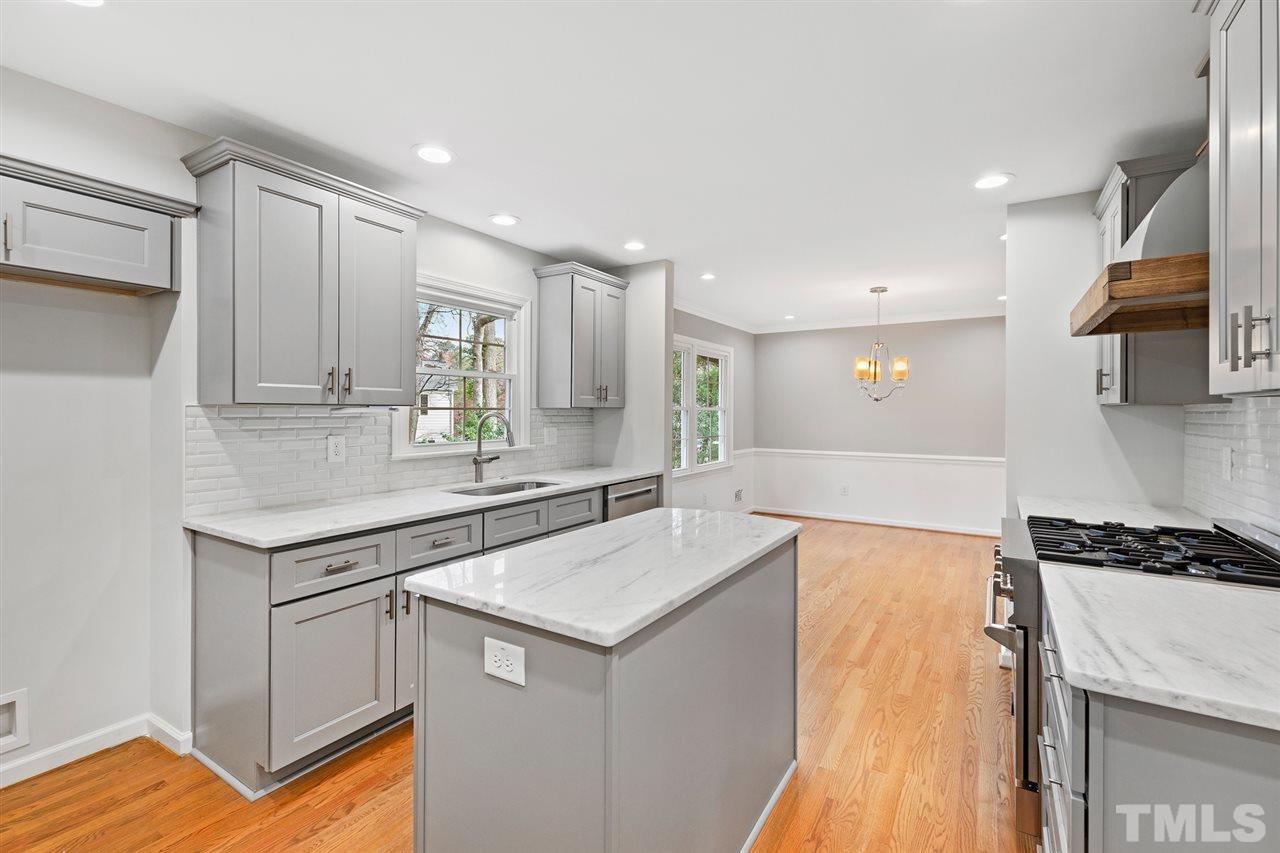 7605 Starling Court Raleigh, NC 27615 - Photo 14 of 30 a kitchen with stainless steel appliances granite countertop a sink and a stove