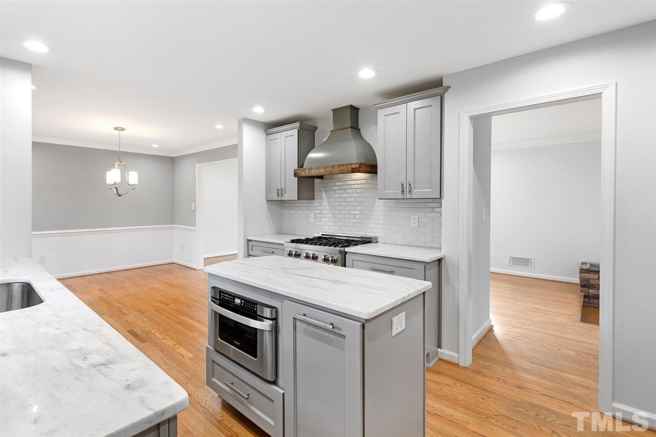 7605 Starling Court Raleigh, NC 27615 - Photo 15 of 30 a kitchen with a stove and a sink