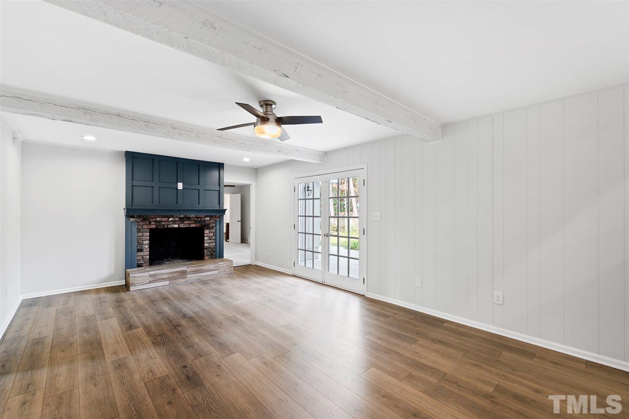 7605 Starling Court Raleigh, NC 27615 - Photo 16 of 30 a view of an empty room with a fireplace and a window