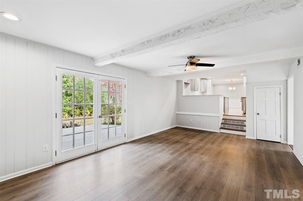 7605 Starling Court Raleigh, NC 27615 - Photo 17 of 30 an empty room with wooden floor and windows