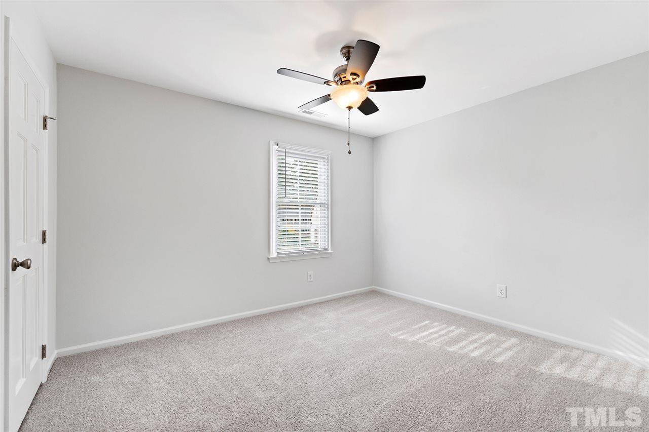 7605 Starling Court Raleigh, NC 27615 - Photo 21 of 30 an empty room with a window and a fan