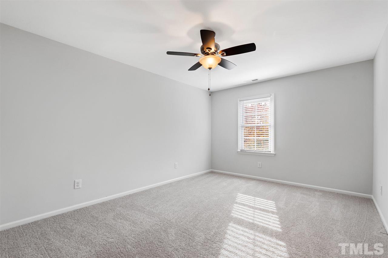 7605 Starling Court Raleigh, NC 27615 - Photo 22 of 30 a view of a room with a ceiling fan and a window
