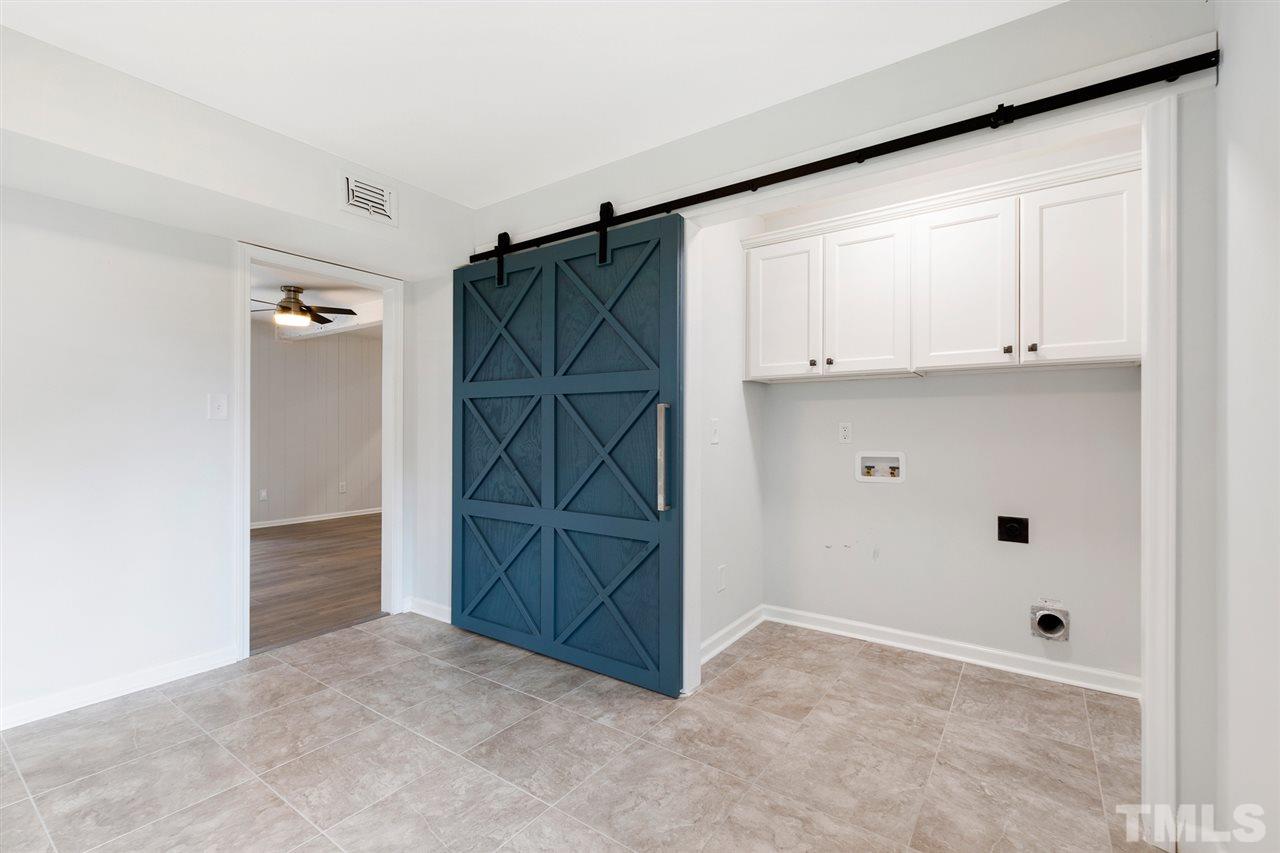 7605 Starling Court Raleigh, NC 27615 - Photo 28 of 30 an empty room with cabinet and mirrors