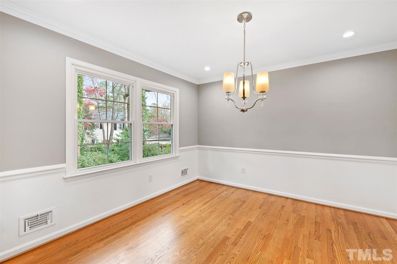 7605 Starling Court Raleigh, NC 27615 - Photo 8 of 30 a view of a room with wooden floor and chandelier