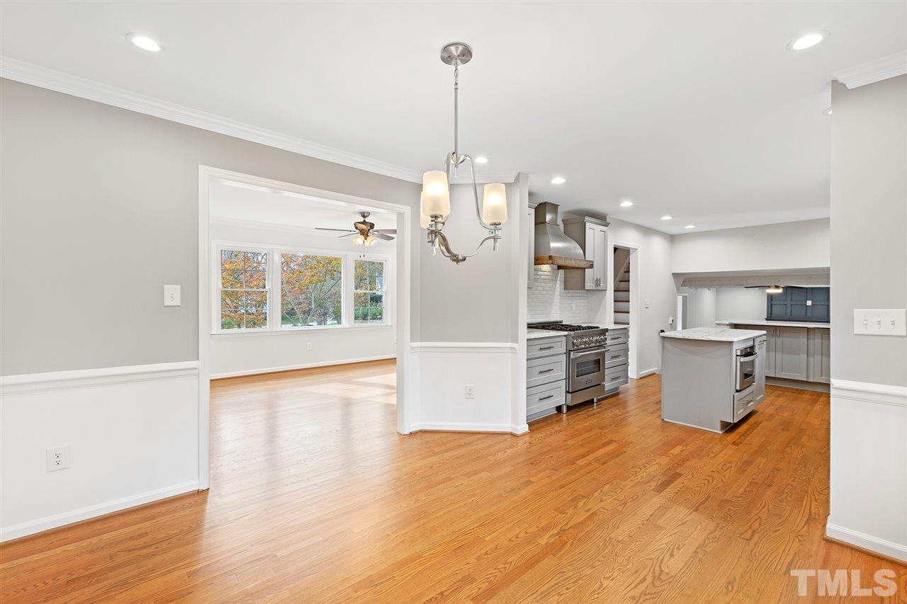7605 Starling Court Raleigh, NC 27615 - Photo 10 of 30 a view of a kitchen with furniture and wooden floor