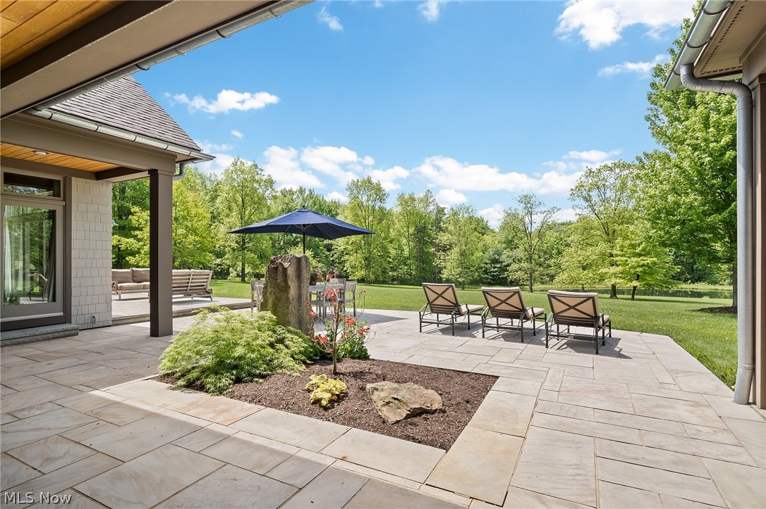 10 Pepper Ridge Road Cleveland, OH 44124 - Photo 30 of 34 The stone patios run across the entire back of the house and serve as a welcoming entryway to the back yard.