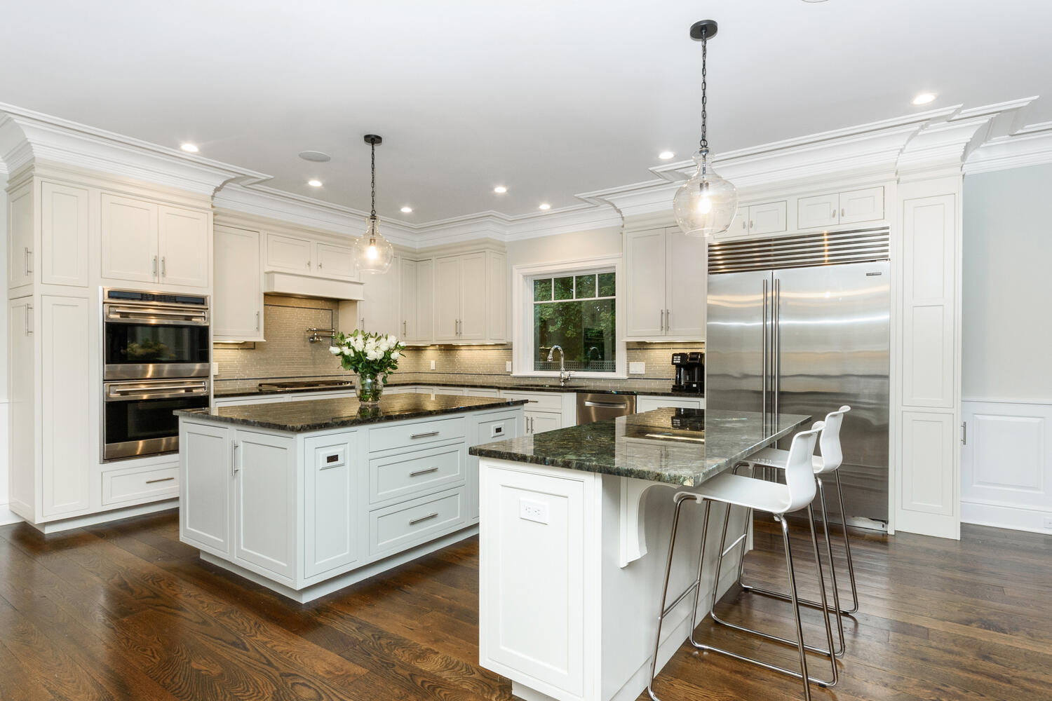 178 Middlesex Road Darien, CT 06820 - Photo 13 of 44 a kitchen with stainless steel appliances granite countertop a sink a stove a refrigerator and island with wooden floor