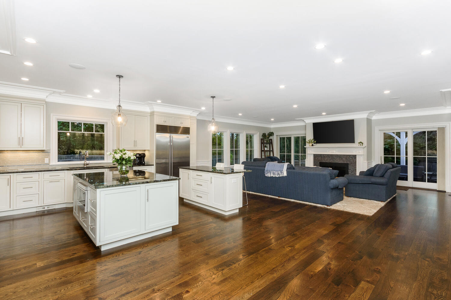 178 Middlesex Road Darien, CT 06820 - Photo 16 of 44 a kitchen with stainless steel appliances kitchen island wooden floors and white cabinets