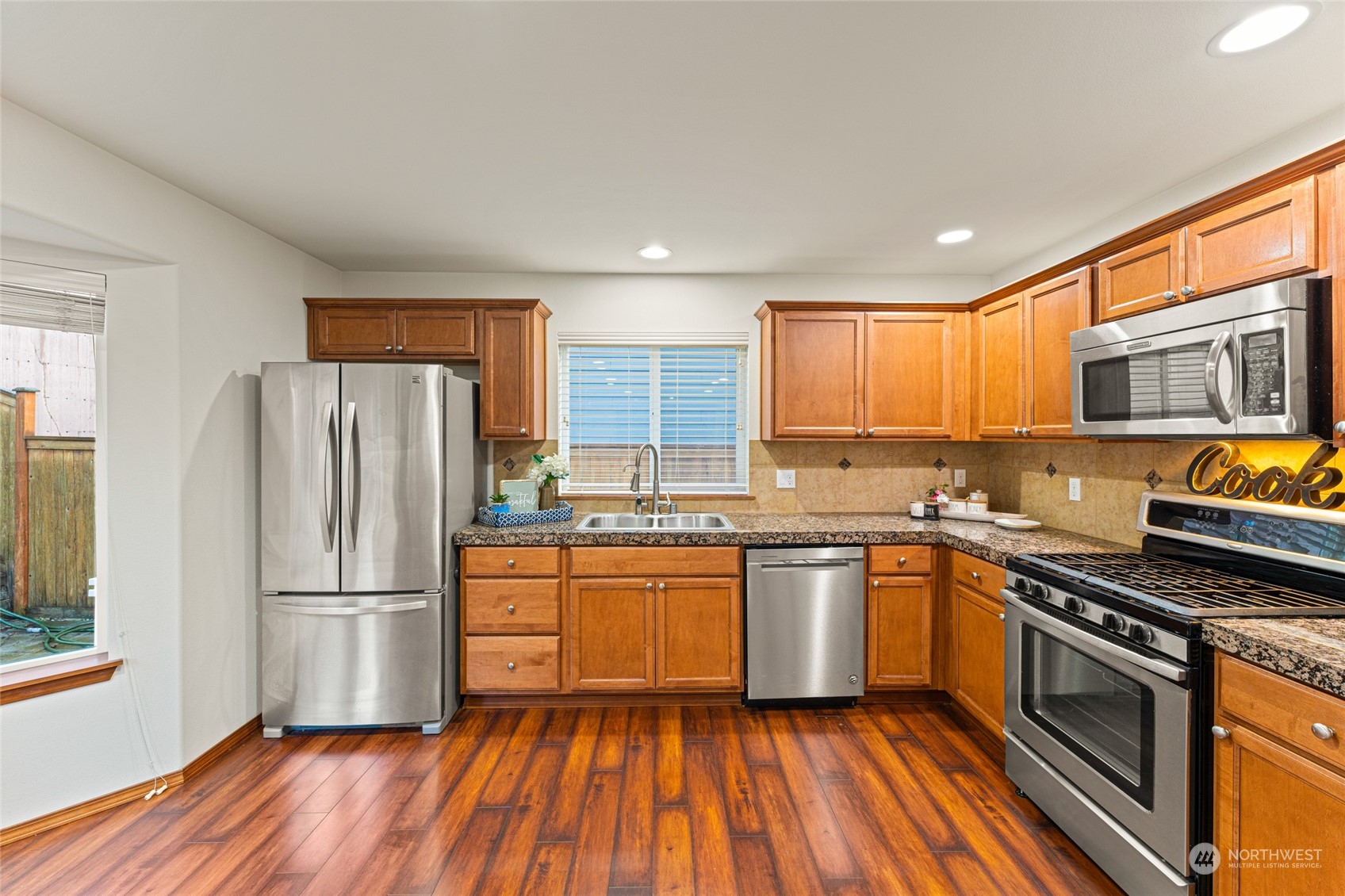 22907 41st Drive Southeast Bothell, WA 98021 - Photo 18 of 39 a kitchen with granite countertop stainless steel appliances and wooden cabinets