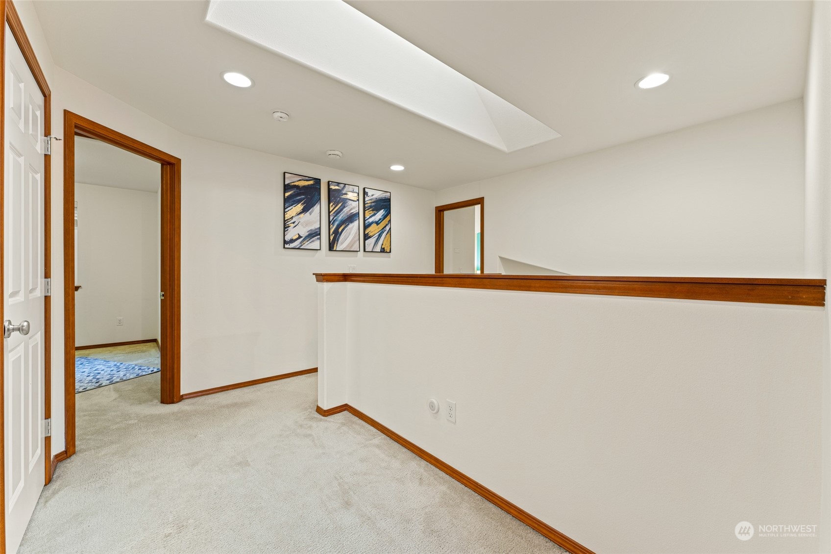 22907 41st Drive Southeast Bothell, WA 98021 - Photo 28 of 39 a view of a hallway with paintings on the wall