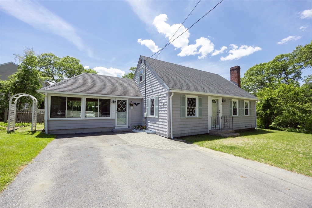 4 Cypress Road Natick, MA 01760 - Photo 3 of 32 a front view of a house with a garden and yard