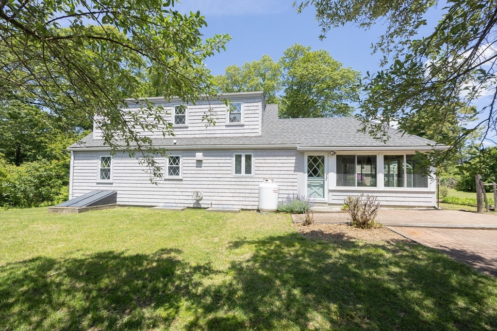 4 Cypress Road Natick, MA 01760 - Photo 5 of 32 a front view of a house with a yard