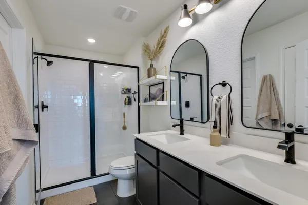 a bathroom with a toilet sink and mirror