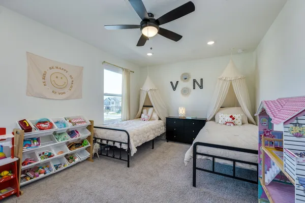 a bedroom with furniture and a baby crib