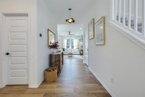 a view of a living room and hallway with wooden floor