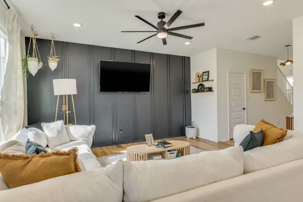 a living room with furniture and a flat screen tv